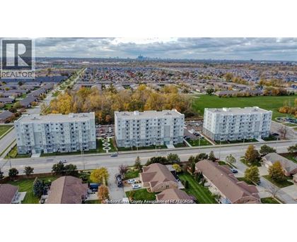 A realtor photo of a residential area with apartment buildings and houses.