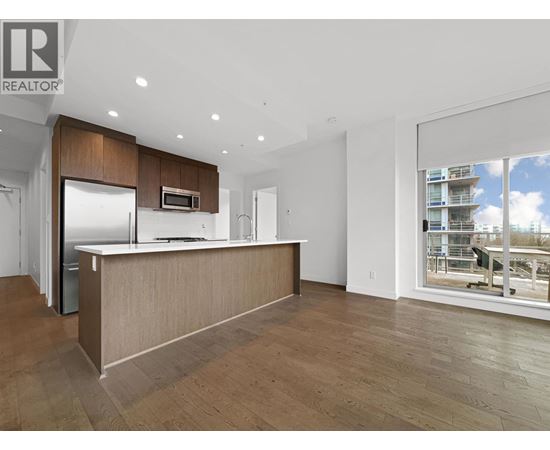 A modern kitchen with wooden cabinets and a large island.