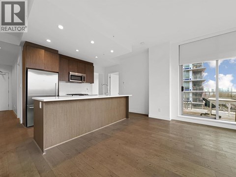 A modern kitchen with wooden cabinets and a large island.