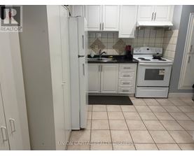 A kitchen with white cabinets and appliances.