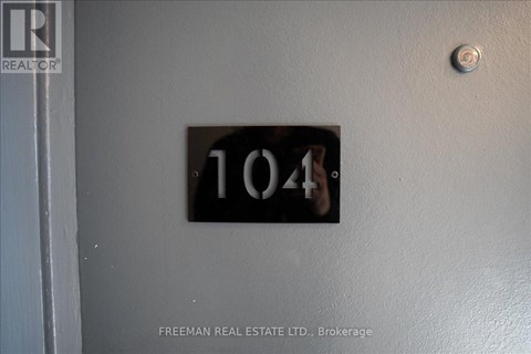 A door with a number 104 on it and a Freeman Real Estate Ltd. logo.