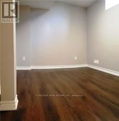 A room with wooden floors and white walls.