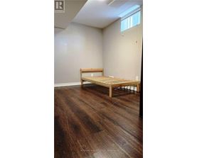 A room with wooden flooring and a bench.