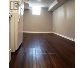 A room with wooden flooring and a window.