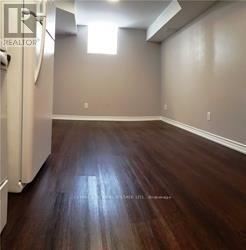 A room with wooden flooring and a window.