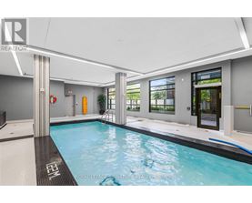 A swimming pool inside a building with a white ceiling.