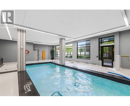 A swimming pool inside a building with a white ceiling.