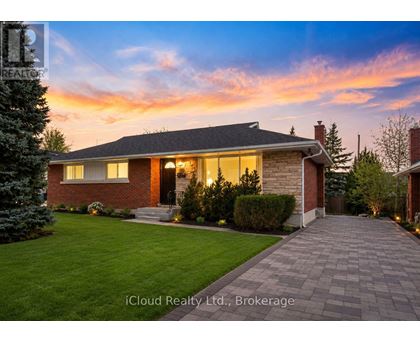 A house with a brick exterior and a stone pathway leading to the front door.