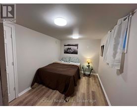 A bedroom with a bed, a nightstand, and a lamp.