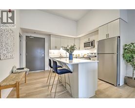 A kitchen with a table and chairs.