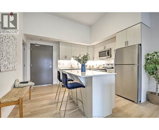 A kitchen with a table and chairs.