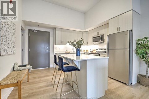 A kitchen with a table and chairs.