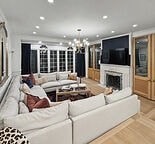 A living room with a white couch and a fireplace.