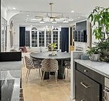 A kitchen with a table and chairs in the middle of the room.