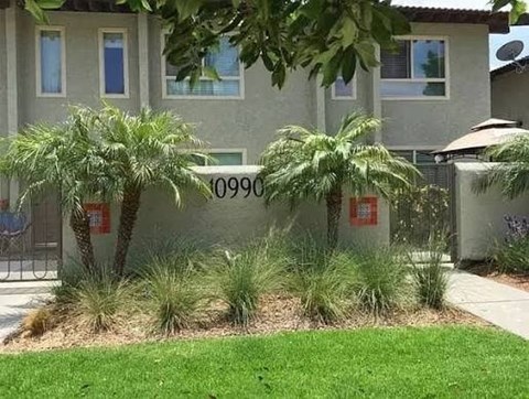 A house numbered 10990 is shown with a green lawn and a palm tree.