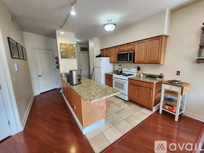 A kitchen with wooden cabinets and a granite countertop.