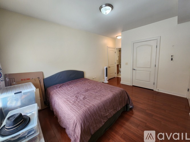 A bedroom with a bed and a hat on the floor.