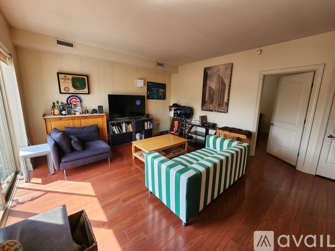 A living room with a striped sofa and a television.
