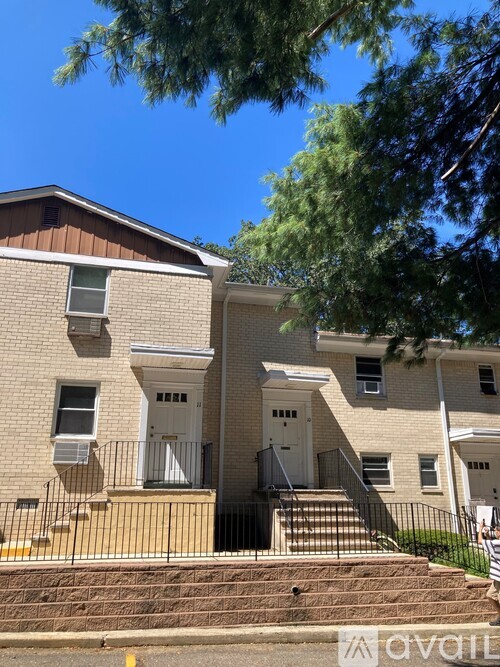 A two-story apartment building with a balcony on the second floor.