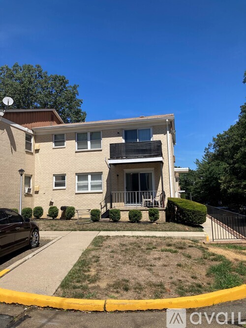 A two-story house with a balcony on the second floor.