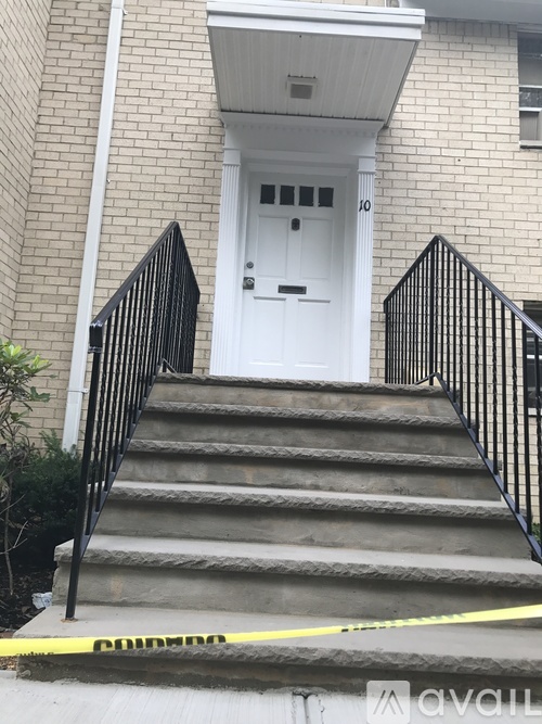 A white door is on the front of a brick building.
