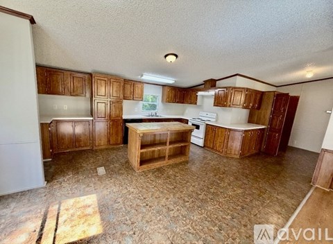 A kitchen with wooden cabinets and a white fridge.