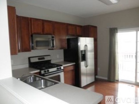 A kitchen with wooden cabinets and stainless steel appliances.