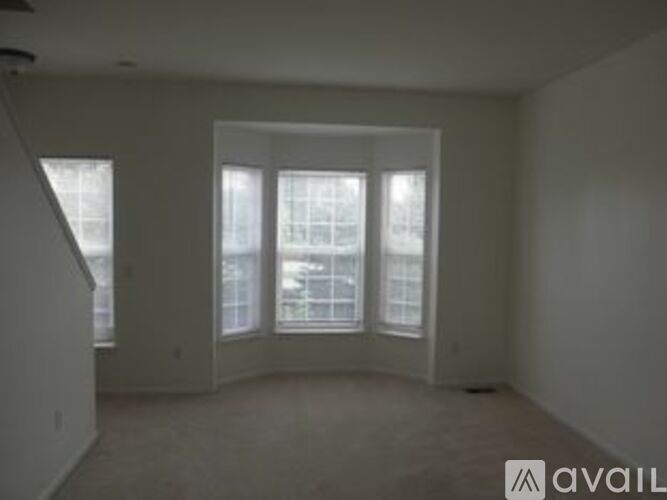 A room with a large window and a door.