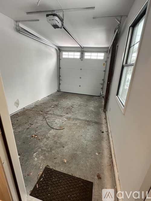A garage with a white door and a window.