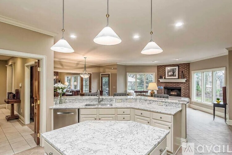 A kitchen with a marble countertop and a brick fireplace.