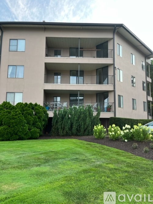 Apartment building with a green lawn in front.