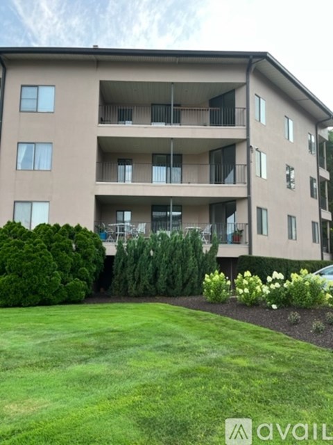 Apartment building with a green lawn in front.