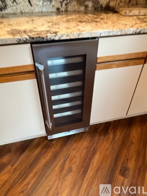A kitchen with a white counter top and a brown vent.