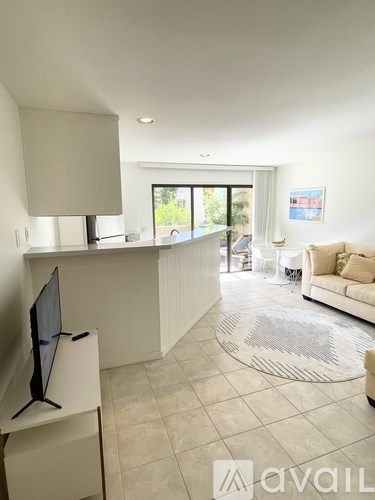 A living room with a television and a couch.