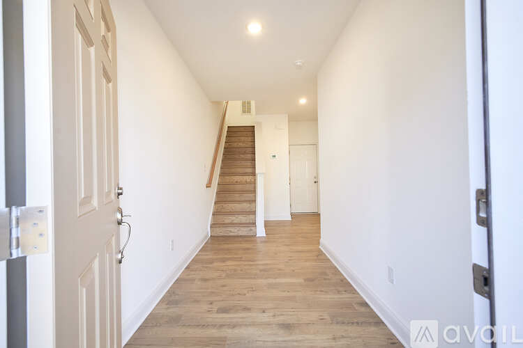 A long hallway with a staircase in the distance.