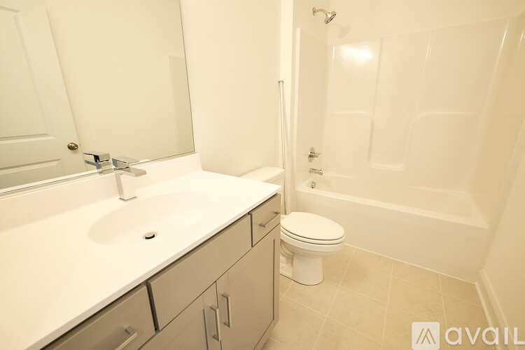 A bathroom with a toilet, sink, and bathtub.