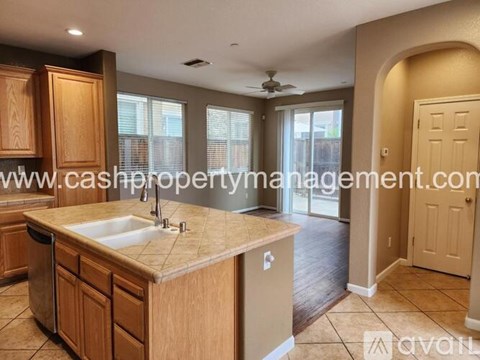 A kitchen with wooden cabinets and a beige countertop.