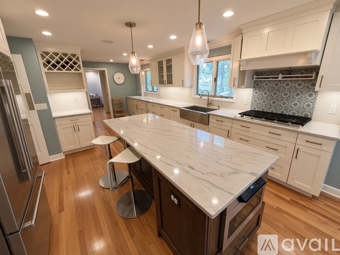 A kitchen with a marble countertop and modern appliances.