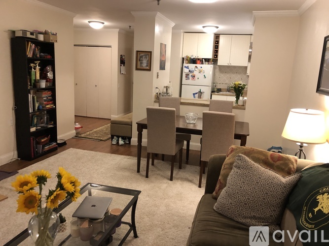 A living room with a couch, chairs, and a coffee table.