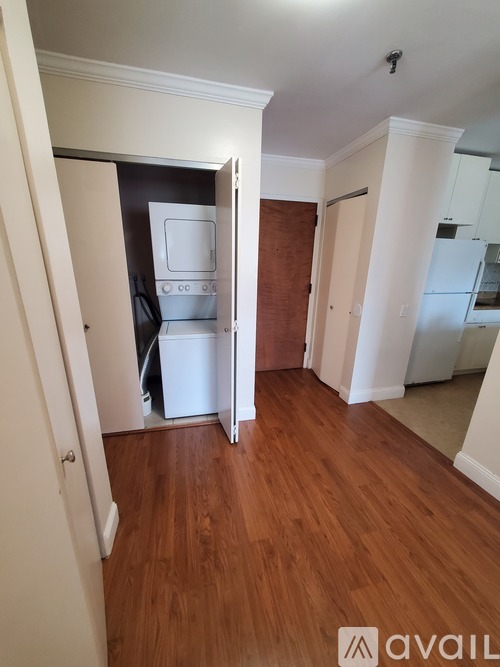 A kitchen area with a white fridge and a white cabinet.
