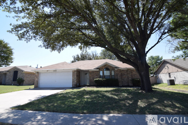 A house with a tree in front of it.
