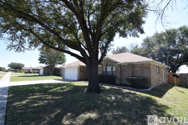 A house with a tree in front of it.