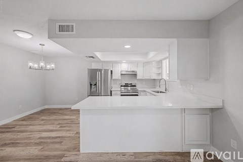 A modern kitchen with white cabinets and a large island.