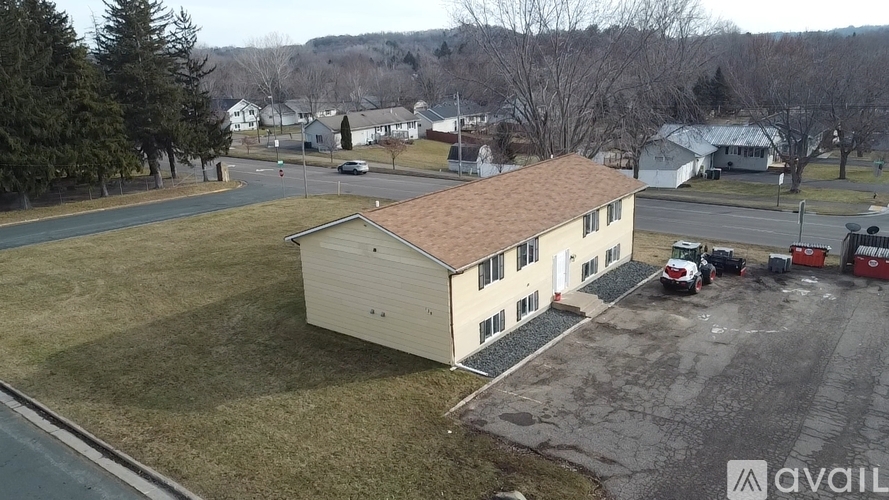 A large building with a parking lot in front of it.