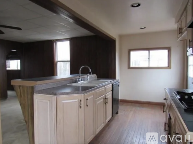 A kitchen with a sink and cabinets.