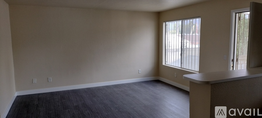 A room with a window and a wall with three switches.