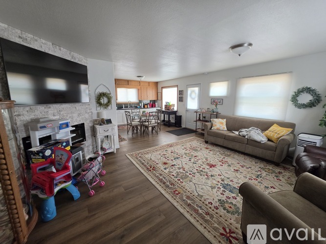 A living room with a fireplace and a TV above it.