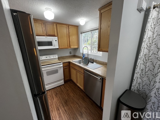 A kitchen with wooden cabinets and stainless steel appliances.