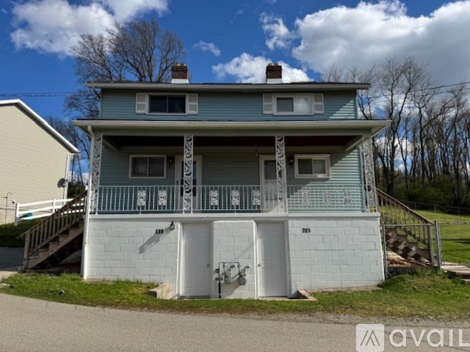 A two-story house with a balcony on the second floor.