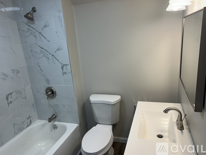 A white toilet sits next to a sink in a bathroom.